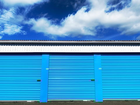 Modern storage facility with clean blue units under blue sky
